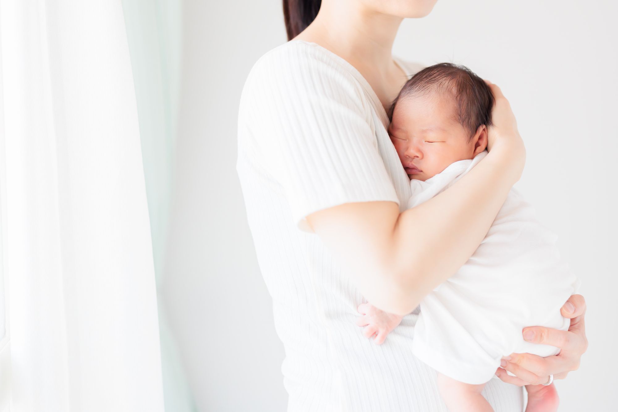 新生児を抱くお母さん
